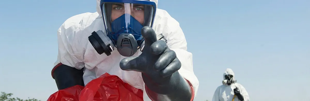 sewage clean up technician wearing protective gear handling biohazard materials in Columbus, OH